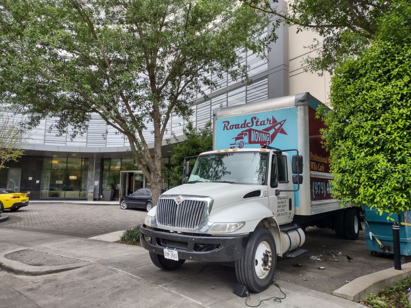 Moving truck parked in front of a large office building in Bryan-College Station, Tx