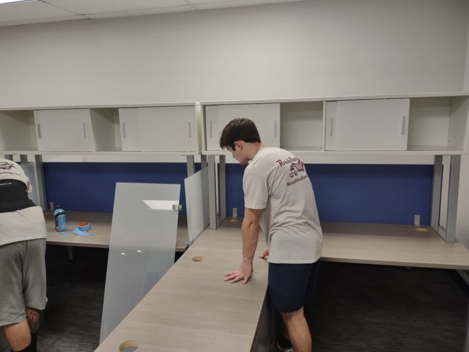 Man assembling furniture for commercial moving services in Bryan-College Station, TX