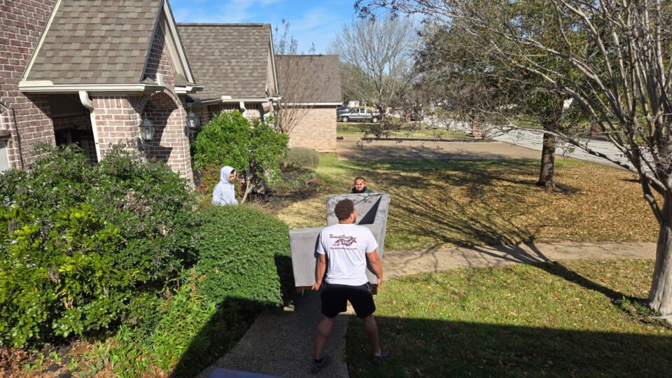 crew members moving a couch